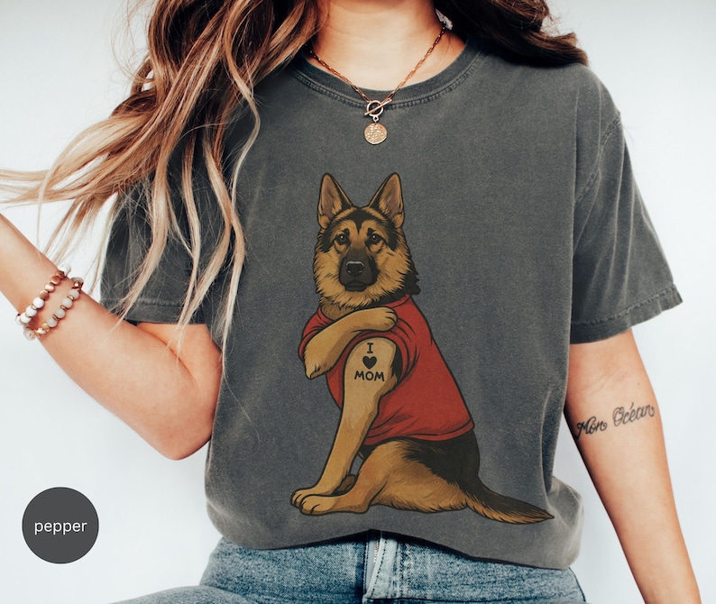 German Shepherd dog illustration wearing a red shirt, lifting sleeve to reveal “I love mom” tattoo, vintage style retro pet graphic, bold clean lines, centered composition, perfect for dog lovers and animal themed apparel designs