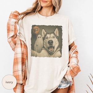 Startled Husky taking a Halloween selfie with a sheet ghost holding an orange BOO balloon in a distressed vintage photo design.