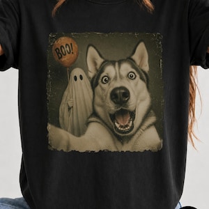 Startled Husky taking a Halloween selfie with a sheet ghost holding an orange BOO balloon in a distressed vintage photo design.