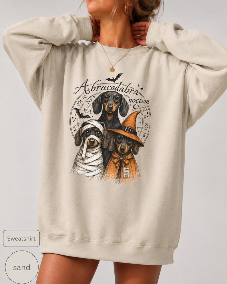 Dachshund Halloween long sleeve and sweatshirt design with three black and tan dogs, mummy wraps, orange witch hat, bats and spell symbols.