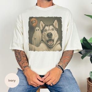 Startled Husky taking a Halloween selfie with a sheet ghost holding an orange BOO balloon in a distressed vintage photo design.