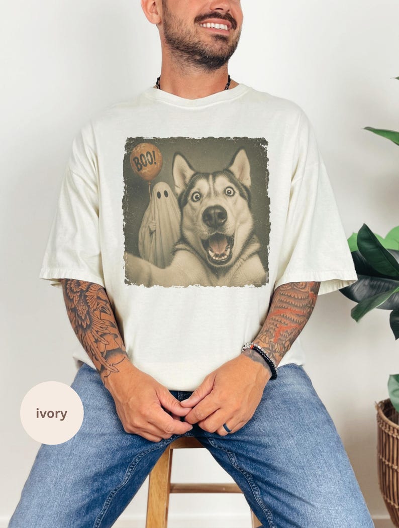 Startled Husky taking a Halloween selfie with a sheet ghost holding an orange BOO balloon in a distressed vintage photo design.