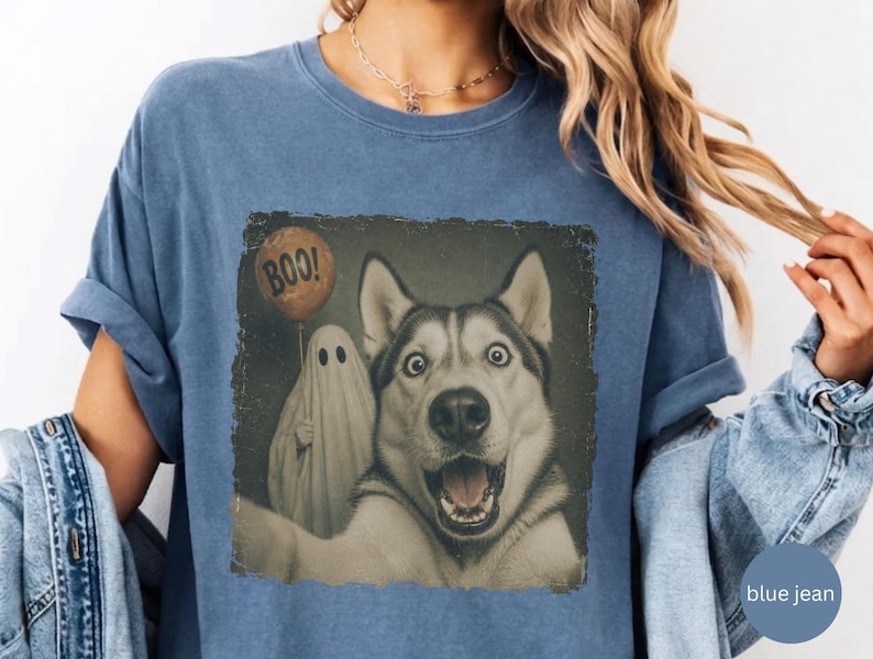 Startled Husky taking a Halloween selfie with a sheet ghost holding an orange BOO balloon in a distressed vintage photo design.