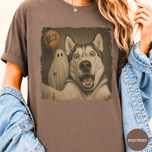 Startled Husky taking a Halloween selfie with a sheet ghost holding an orange BOO balloon in a distressed vintage photo design.