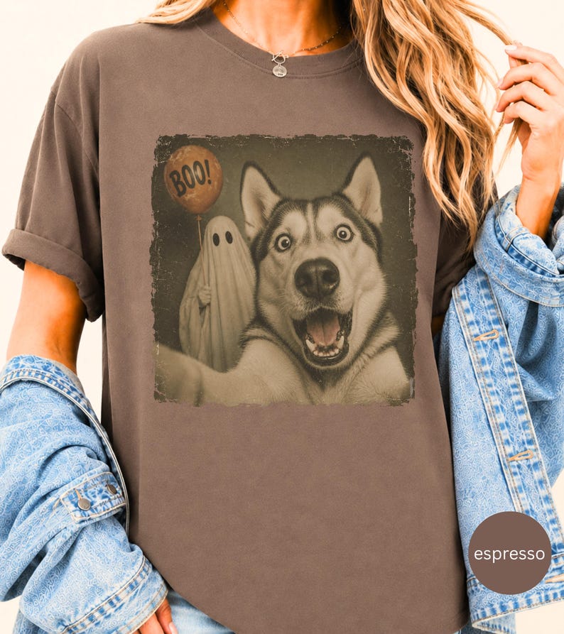 Startled Husky taking a Halloween selfie with a sheet ghost holding an orange BOO balloon in a distressed vintage photo design.