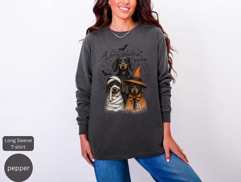 Dachshund Halloween long sleeve and sweatshirt design with three black and tan dogs, mummy wraps, orange witch hat, bats and spell symbols.
