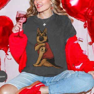 German Shepherd dog illustration wearing a red shirt, lifting sleeve to reveal “I love mom” tattoo, vintage style retro pet graphic, bold clean lines, centered composition, perfect for dog lovers and animal themed apparel designs