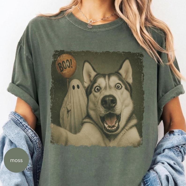 Startled Husky taking a Halloween selfie with a sheet ghost holding an orange BOO balloon in a distressed vintage photo design.