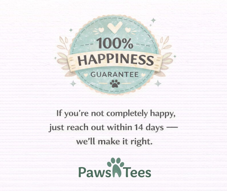 May include: A circular light blue badge with a scalloped edge featuring the text 100% HAPPINESS GUARANTEE and a small paw print. Below, the text reads: If you're not completely happy, just reach out within 14 days &mdash; we'll make it right. Paws Tees.