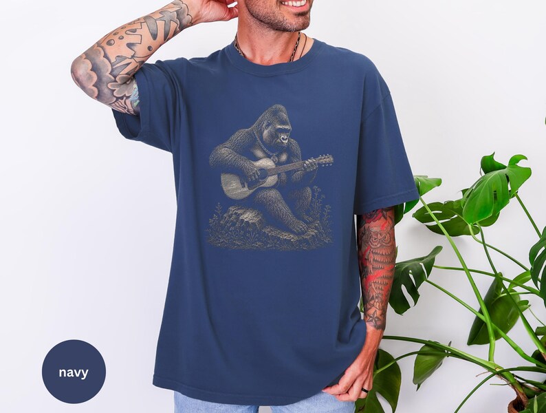 Vintage engraving style gorilla playing an acoustic guitar while seated on a rock, detailed wildlife musician illustration with chain necklace.