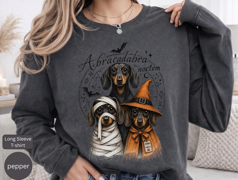 Dachshund Halloween long sleeve and sweatshirt design with three black and tan dogs, mummy wraps, orange witch hat, bats and spell symbols.
