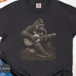 Vintage gorilla guitarist sitting on a rock with acoustic guitar, detailed musician animal illustration for music lovers.