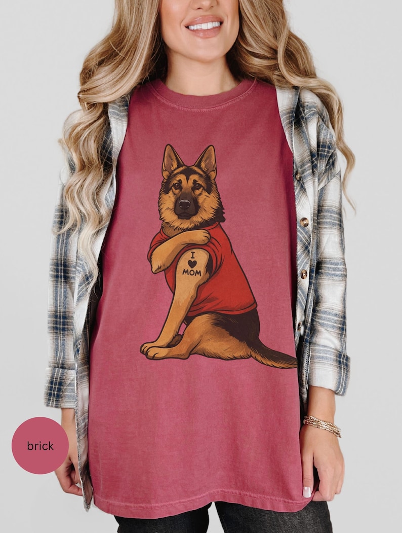 German Shepherd dog illustration wearing a red shirt, lifting sleeve to reveal “I love mom” tattoo, vintage style retro pet graphic, bold clean lines, centered composition, perfect for dog lovers and animal themed apparel designs