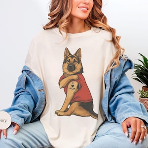 German Shepherd dog illustration wearing a red shirt, lifting sleeve to reveal “I love mom” tattoo, vintage style retro pet graphic, bold clean lines, centered composition, perfect for dog lovers and animal themed apparel designs