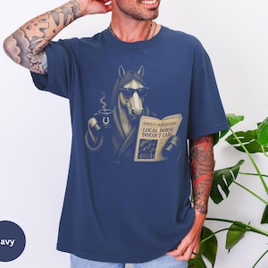 Vintage engraved horse wearing sunglasses and a robe while reading a newspaper and holding a steaming coffee mug. Humorous horse lover design featuring the headline “Local Horse Doesn't Care” in an antique newspaper style. Detailed equestrian artwork with a relaxed, unbothered attitude.