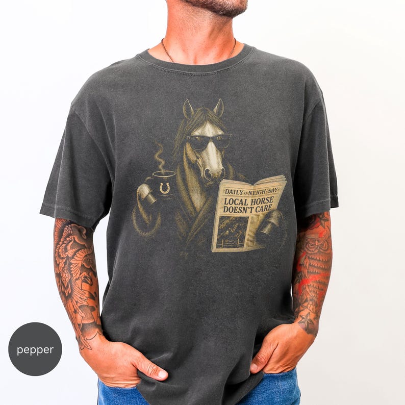 Vintage engraved horse wearing sunglasses and a robe while reading a newspaper and holding a steaming coffee mug. Humorous horse lover design featuring the headline “Local Horse Doesn't Care” in an antique newspaper style. Detailed equestrian artwork with a relaxed, unbothered attitude.