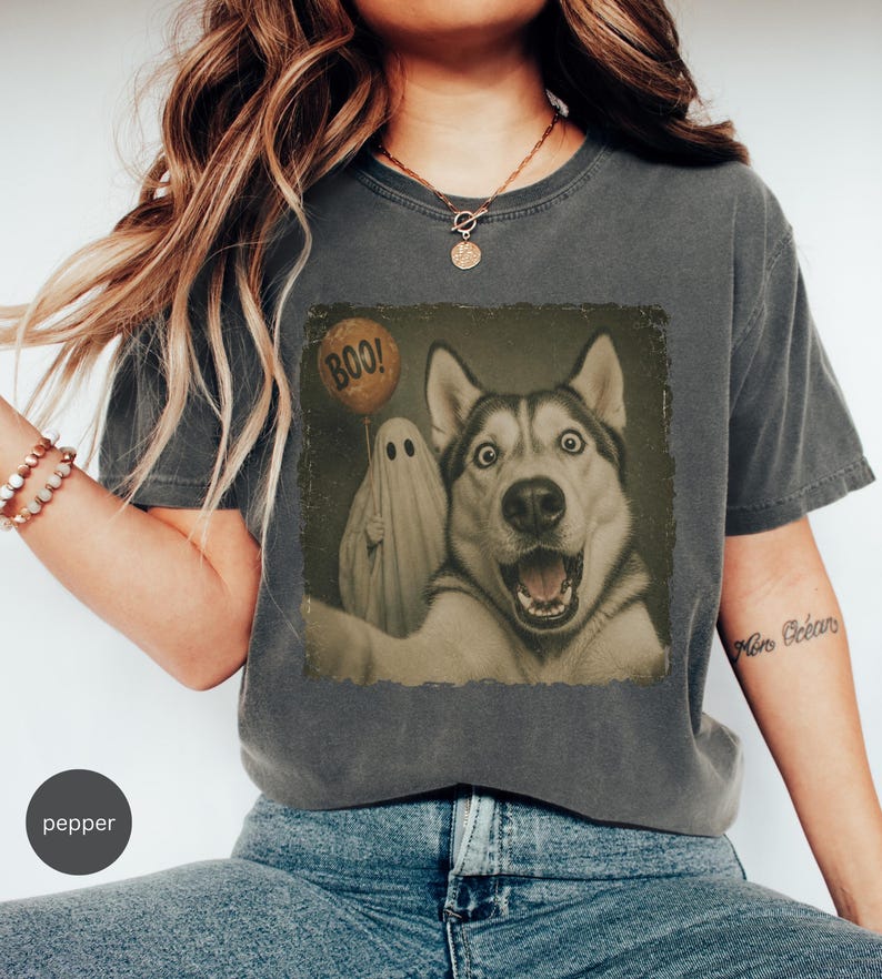 Startled Husky taking a Halloween selfie with a sheet ghost holding an orange BOO balloon in a distressed vintage photo design.