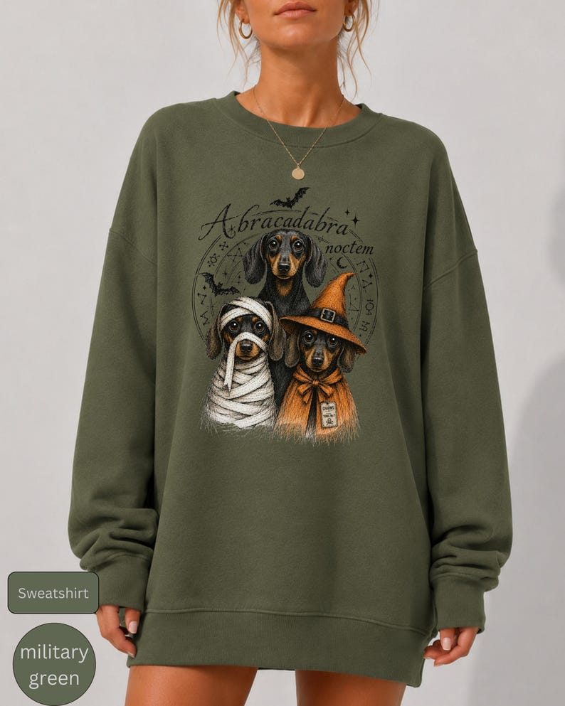Dachshund Halloween long sleeve and sweatshirt design with three black and tan dogs, mummy wraps, orange witch hat, bats and spell symbols.