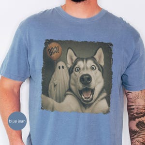 Startled Husky taking a Halloween selfie with a sheet ghost holding an orange BOO balloon in a distressed vintage photo design.