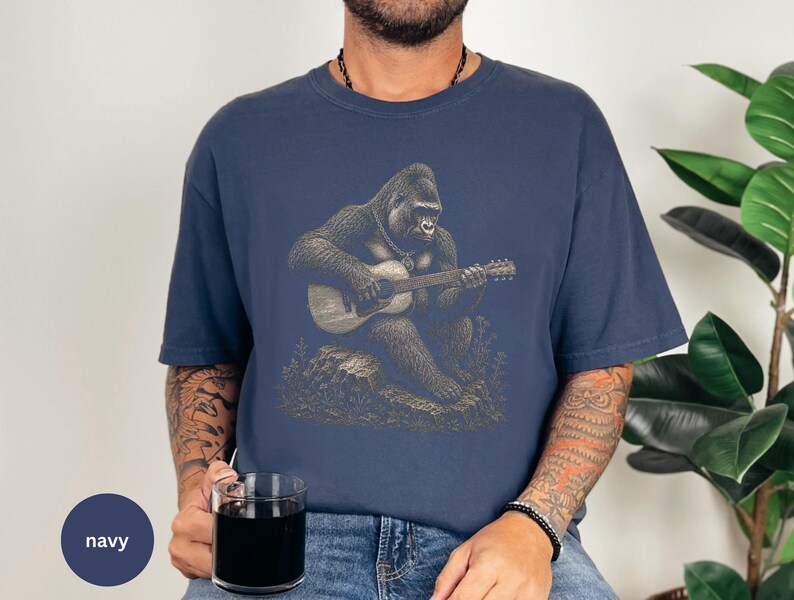 Vintage engraving style gorilla playing an acoustic guitar while seated on a rock, detailed wildlife musician illustration with chain necklace.