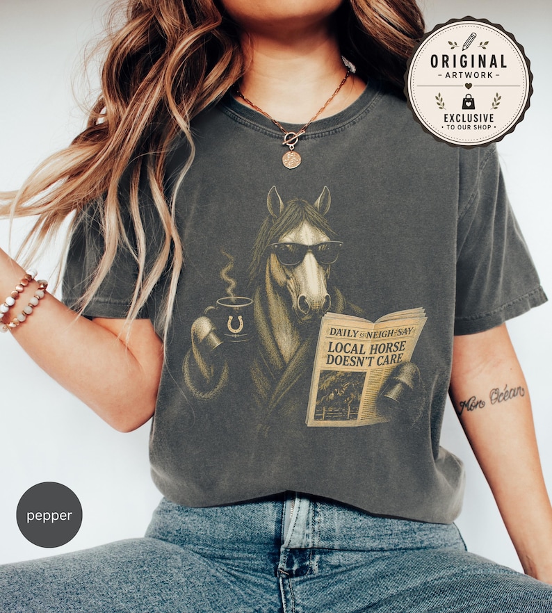 Vintage engraved horse wearing sunglasses and a robe while reading a newspaper and holding a steaming coffee mug. Humorous horse lover design featuring the headline “Local Horse Doesn't Care” in an antique newspaper style. Detailed equestrian artwork with a relaxed, unbothered attitude.