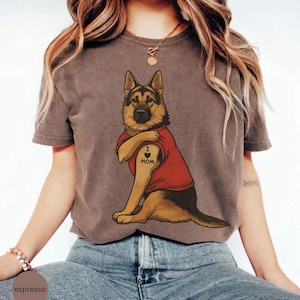 German Shepherd dog illustration wearing a red shirt, lifting sleeve to reveal “I love mom” tattoo, vintage style retro pet graphic, bold clean lines, centered composition, perfect for dog lovers and animal themed apparel designs