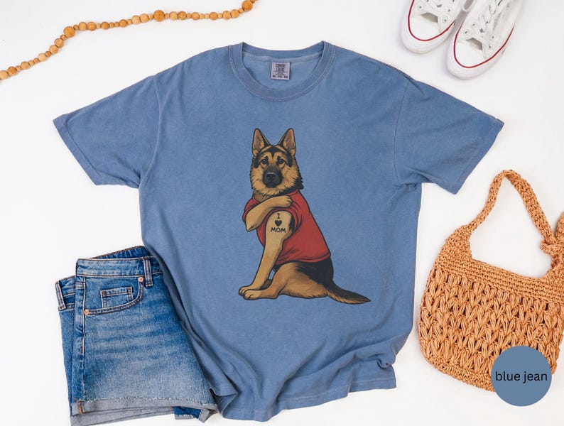 German Shepherd dog illustration wearing a red shirt, lifting sleeve to reveal “I love mom” tattoo, vintage style retro pet graphic, bold clean lines, centered composition, perfect for dog lovers and animal themed apparel designs