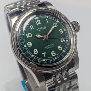 May include: A set of three ceramic mugs with a speckled, matte finish. Each mug is in a different colour: light blue, cream, and grey. The mugs have a simple, modern design and a comfortable handle.