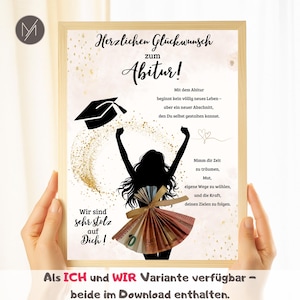 May include: A framed print with a graduation theme. The artwork features a silhouette of a person with arms raised, a graduation cap, and text in German. Gold glitter accents the design. The print is held by hands.