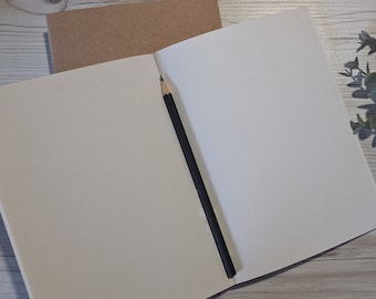 Handmade sketchbook with 160gsm ivory sketching paper. A5 size, stitched spine and rounded corners. Pencil, charcoal, mixed media and pen.