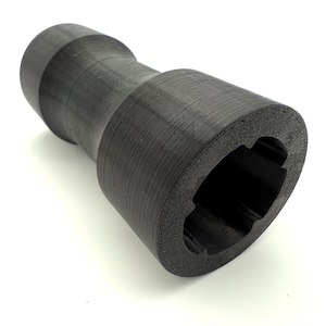 May include: A black, cylindrical bottle opener with a textured surface. The opener has a flared end with a multi-faceted opening. The design features a central, narrower section connecting the two wider ends.