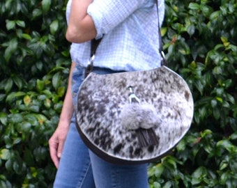 SALE** (was 178.00) -- Large round bottom salt and pepper hair-on cowhide bag with removable tassel ornament