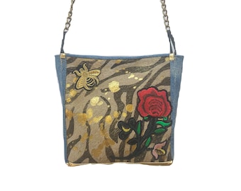 Shoulder bag on zebra print cowhide with denim lambskin, metallic gold and embroidered red roses