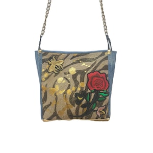 Shoulder bag on zebra print cowhide with denim lambskin, metallic gold and embroidered red roses