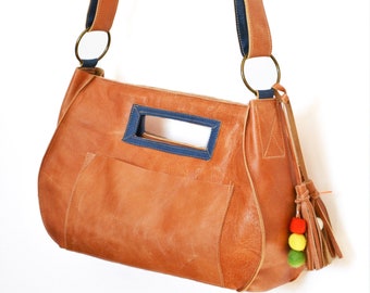 Brown leather shoulder bag with multi-color strap and trim