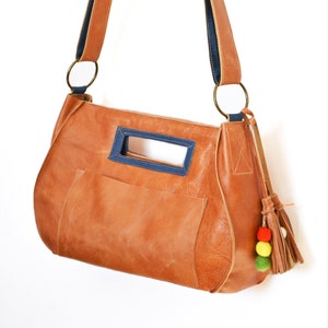 Bolso bandolera de cuero marrón con correa y adornos multicolores