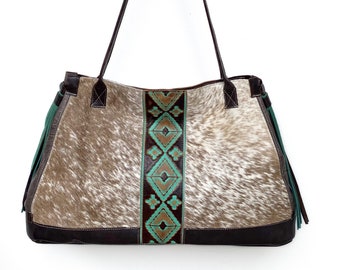 SALE (was 268.00) Light brown and white hair-on cowhide XL tote with tooled turquoise leather trim and tassels