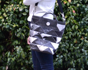 Large hair-on cowhide chevron patchwork tote in black and white with short handles and adjustable shoulder strap