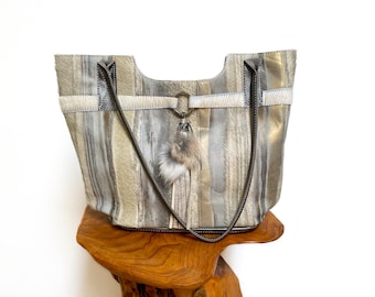 All leather bag in neutral beach tones with silver rings and rabbit-fur trim