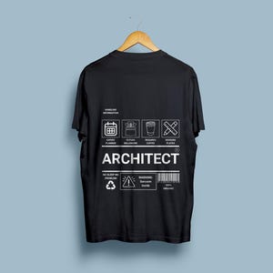 May include: Black t-shirt with a white graphic design that says "ARCHITECT" and includes icons representing an expert planner, future millionaire, coffee drinker, and plate devourer. The graphic also includes the text "Handling Information", "No Sleep No Problem", "Warning: Sarcasm Inside", and "100% Organic".