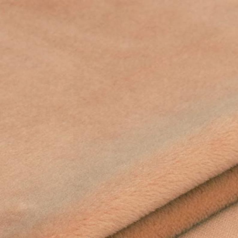 Soft plush fabric texture of race car pillow, close-up of cozy velvet-like material, gentle on child skin