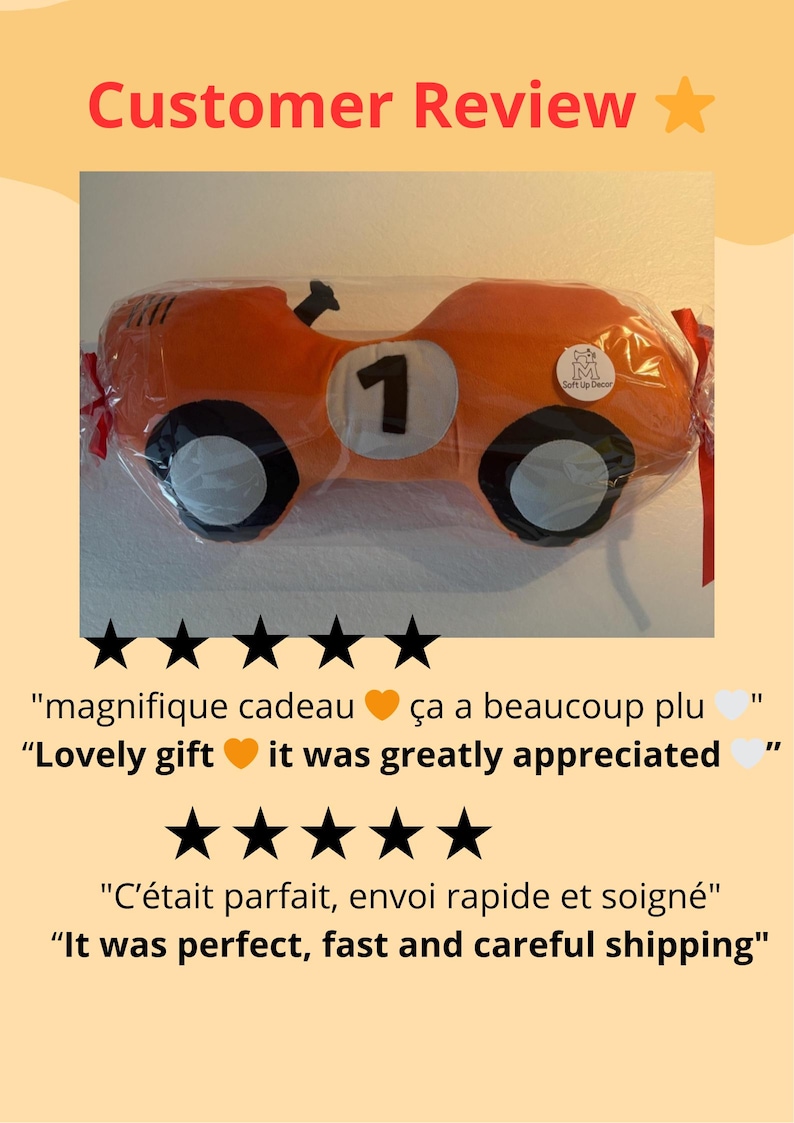 May include: An orange race car shaped plush pillow featuring a white circular patch with the black number 1, black and white wheels, and a small circular logo tag, all enclosed in clear plastic packaging with red ribbon ties on the sides.