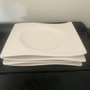 May include: A handmade, wooden serving tray with a natural finish. The tray features a rectangular shape with raised edges and two handles. The wood grain is visible, adding to its rustic charm. Dimensions are approximately 16 inches long and 10 inches wide.