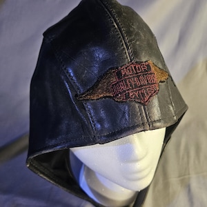 May include: A white ceramic mug with a black handle and the text "But First, Coffee" in a handwritten style. The mug is on a white surface. The mug is 4 inches tall.