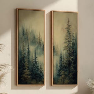 May include: Two framed vertical landscape art prints. Each print depicts a misty forest scene with tall evergreen trees in shades of green and blue. The frames are a light wood colour. The Stag & Print logo is in the upper left corner.