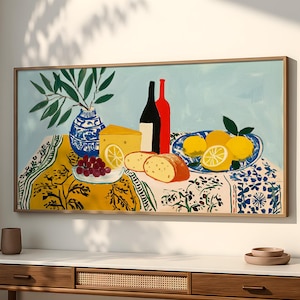 May include: A framed art print depicts a still life with a blue and white vase holding green leaves, red and black wine bottles, cheese, bread, grapes, and lemons. The artwork is set on a table with a patterned tablecloth.