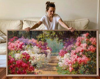 May include: A large rectangular framed painting depicting a garden scene with a person in a white dress and straw hat walking along a path. The landscape is filled with vibrant pink, white, and purple flowering bushes under green trees.