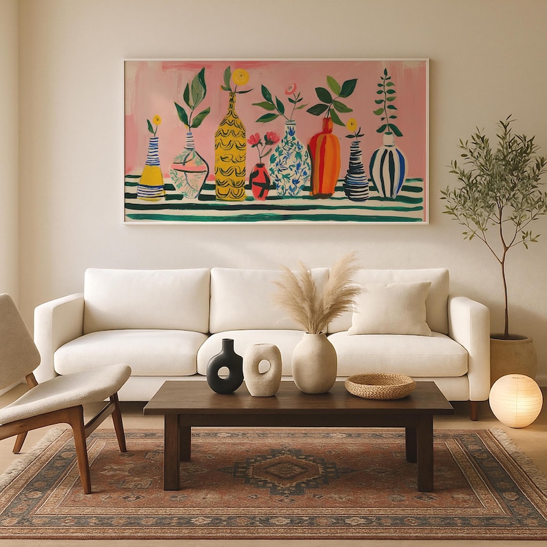 a living room filled with furniture and a painting on the wall