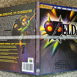 May include: A Nintendo Player's Guide for The Legend of Zelda: Majora's Mask. The cover features a colorful illustration of a character and the game's logo. The guide is an official Nintendo product.