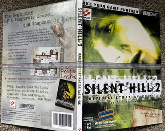 Può includere: Una guida strategica ufficiale di Silent Hill 2 di Dan Birlew per PlayStation 2. La copertina presenta un volto dai toni verdi, il titolo del gioco e un logo Blockbuster. Il retro mostra informazioni sul gioco, una mappa e un codice a barre.